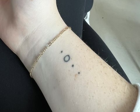 Ava Graf 23 shows off her four dot tattoo that symbolizes her family. 