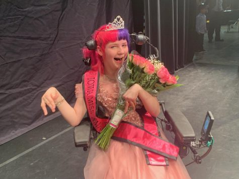 Aria holds flowers after winning the Miss Amazing pageant