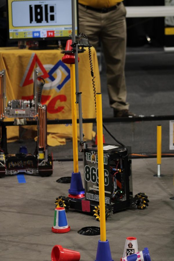 Trobotixs robot scores a cone on the highest junction.