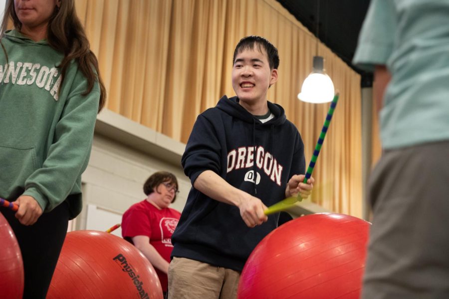 Paraeducator Eric Kim 14 plays with the ball drum circle at the Community Inclusion Club Talent Show on April 20. 