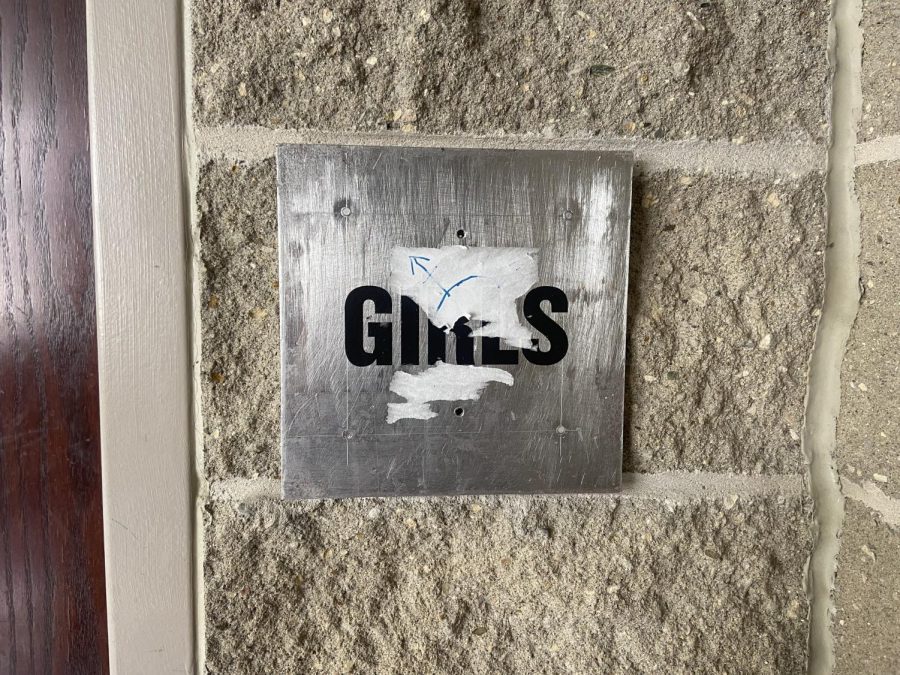 After students peeled the gendered bathroom signs off of the walls, the school had the signs painted on instead. Students have since tried to scratch them off and cover them up. 