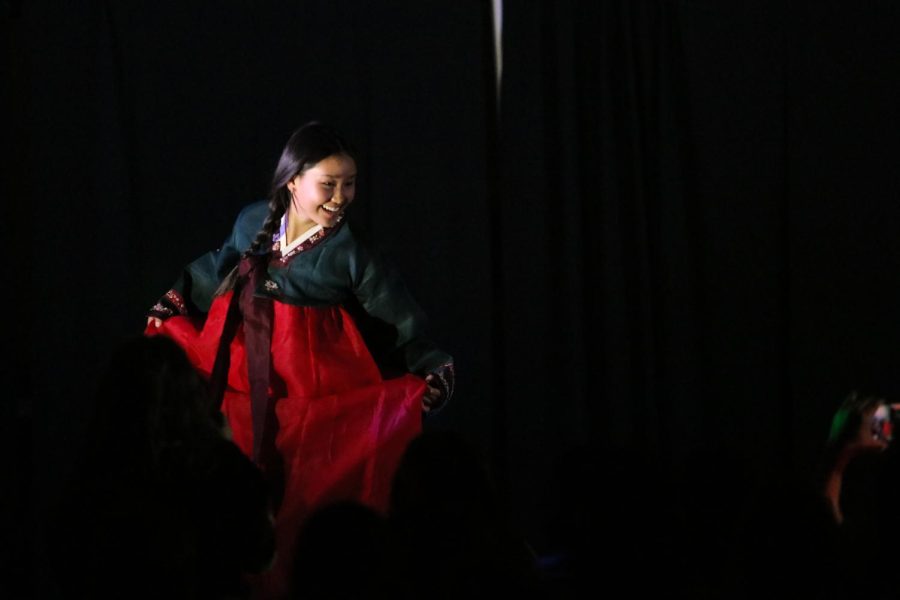 Ijin Shim 24 poses on stage wearing a traditional Korean hanbok at Walk It Out April 8.