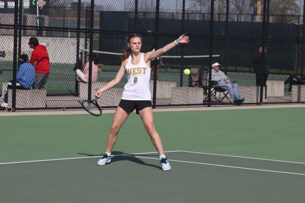 Marie Stier ’25 prepares for a forehand during her match at the girls tennis meet at West against Liberty High on April 19. 
