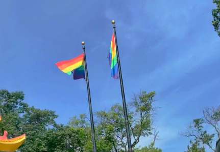 Two pride flags flying proudly in Philadelphia, Pennsylvania.
