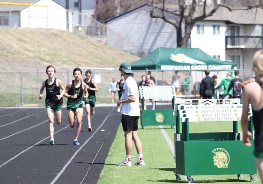 Senior Asher Overholt cheers on West high runners in the open 1600-meter race. 