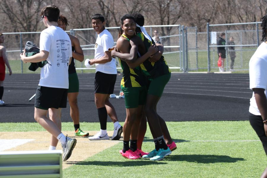 Izaiah Loveless 24 and Moustafa Tiea 25 embrace after West takes home first place in the distance medley on Apr. 8, 2023. 