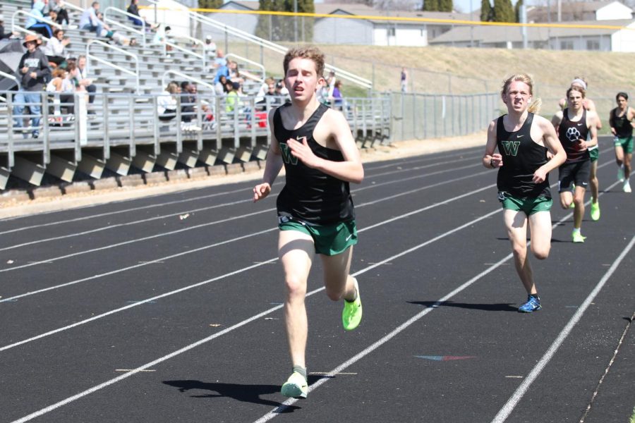 Andrew Polgreen 23 and Cade Benson 24 finish the final lap of the 1600-meter race on Apr. 8, 2023. 