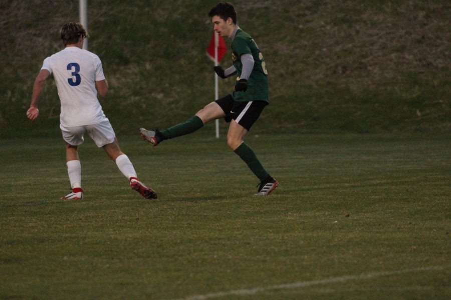 After passing the ball, Erwann Charles 25 maintains his stance in order to secure a goal.