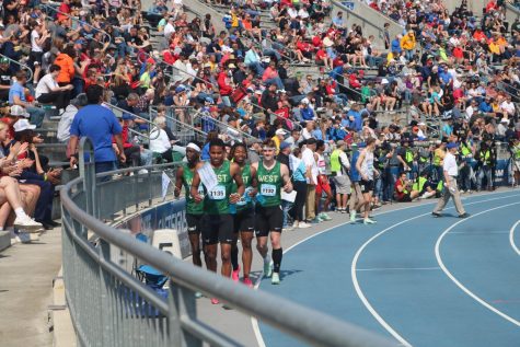 Aidan Jacobson 24, Todd Rent 24, Izaiah Loveless 24 and Moustafa Tiea 25 take a victory lap after winning the distance medley relay. 