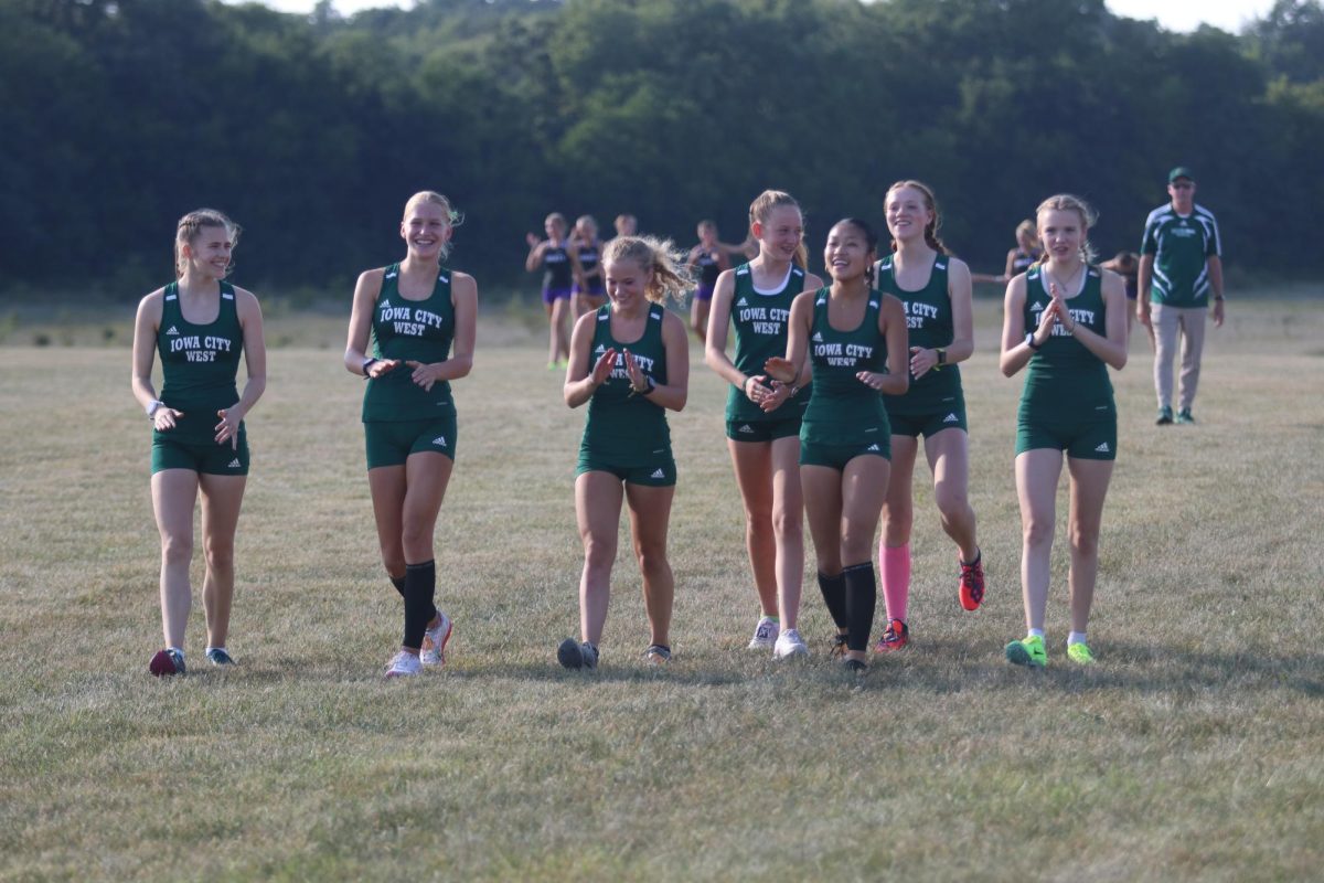 West runners chant as they prepare to compete in the Trojan Early Bird Invite Aug. 28. 