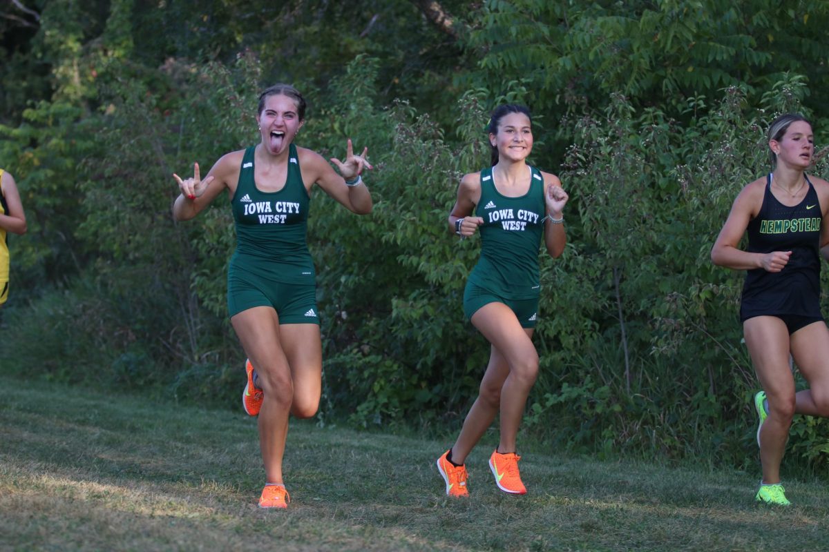 Juniors Lily McConnell and Annie Dickens have fun while they run at the Ashton Cross-Country Course. 