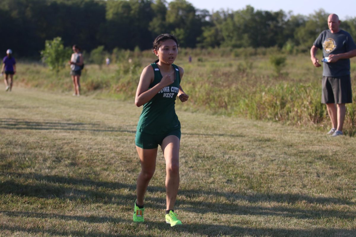 Tina Hong 25 charges the finish line to place fourth in the junior varsity race.