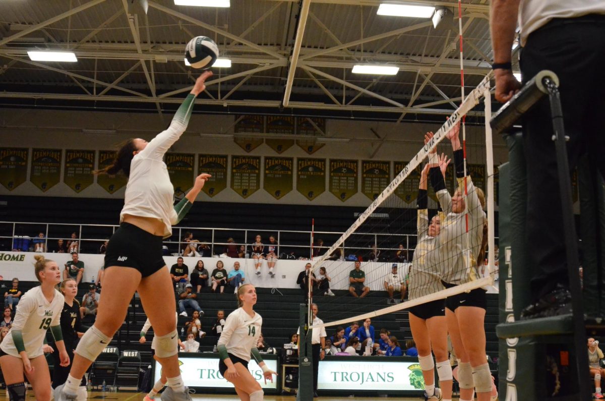 Gianna Liu 25 reaches to return the ball over the net during a point against Mid-Prarie Sep. 9.