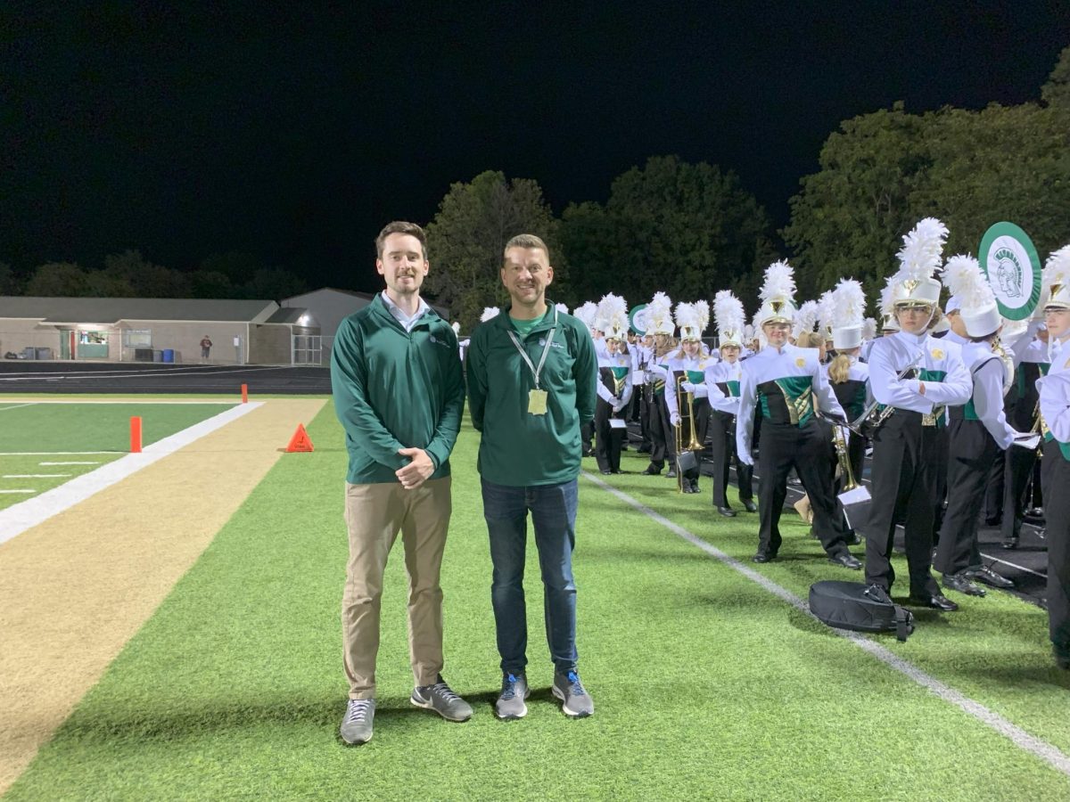 Ryan Middleton (left) and Brian Zeglis (right) stand with the Trojan Marching Band before the half-time show.