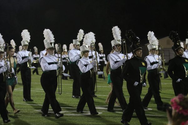 The band marches onto the field for the half-time show.