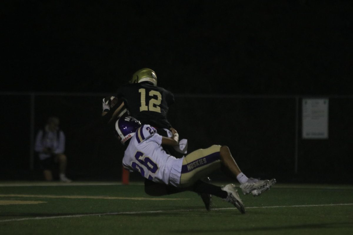 Mason Goering 26 gets tackled by a Muskie Sept. 8 against Muscatine. 