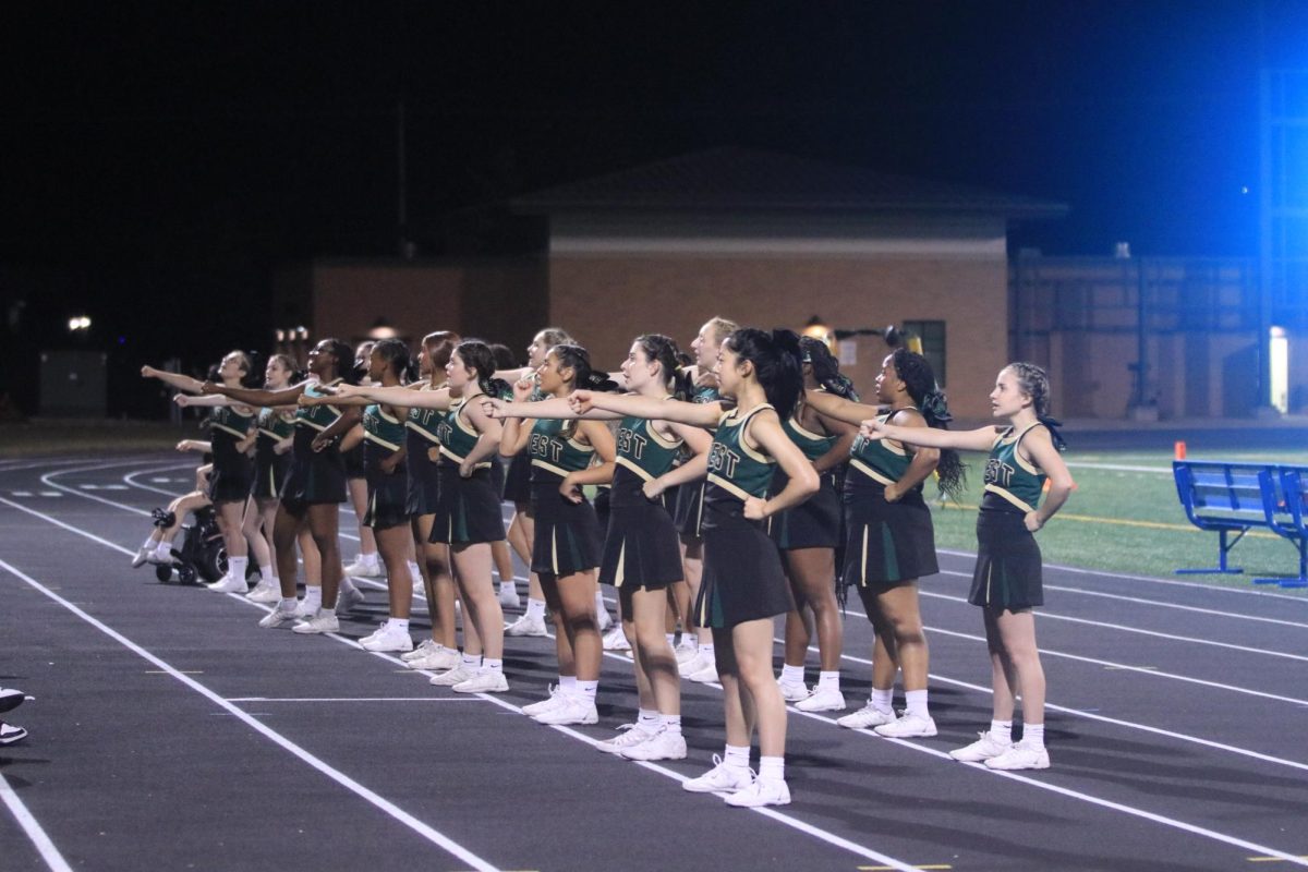 West High cheerleaders perform a cheer during the second half to keep the crowd excited. 
