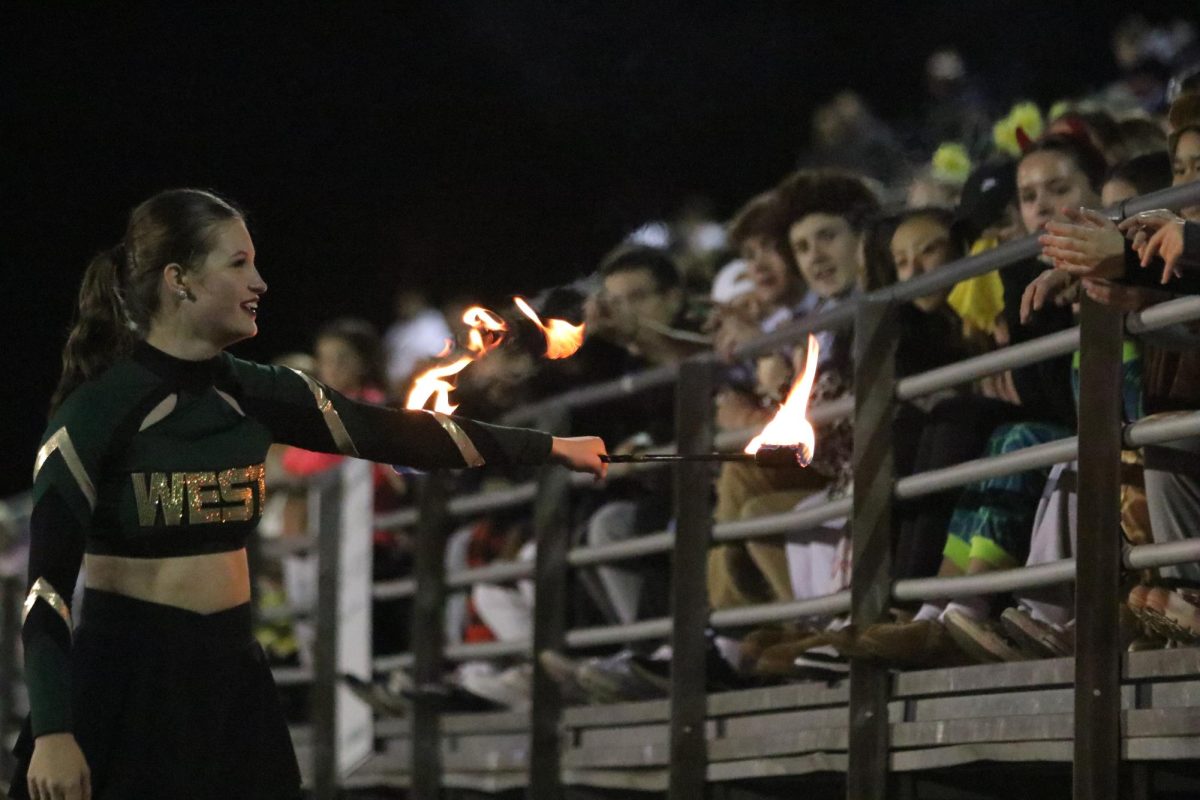 Ashley Niemiec 25 twirls her baton in front of the student section during halftime Oct. 20. 