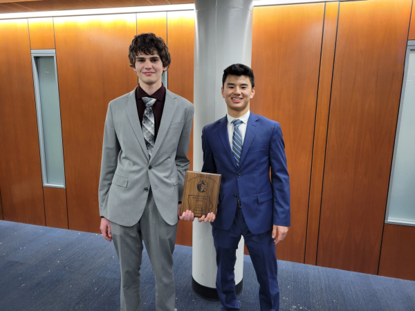 Ben Kleiman 24 and Andrew Dong pose with their State Championship plaque. 