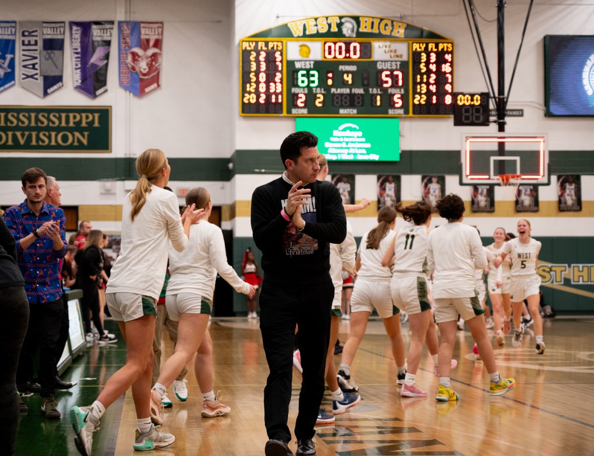Coach Frese celebrates the girls victory against City High Dec 22. The girls won 63-57 in the Double Header.