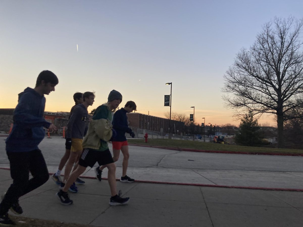 A group of varsity runners start their long run on a Monday afternoon. Although its currently light out, the sun will be completely down by the time they get back.