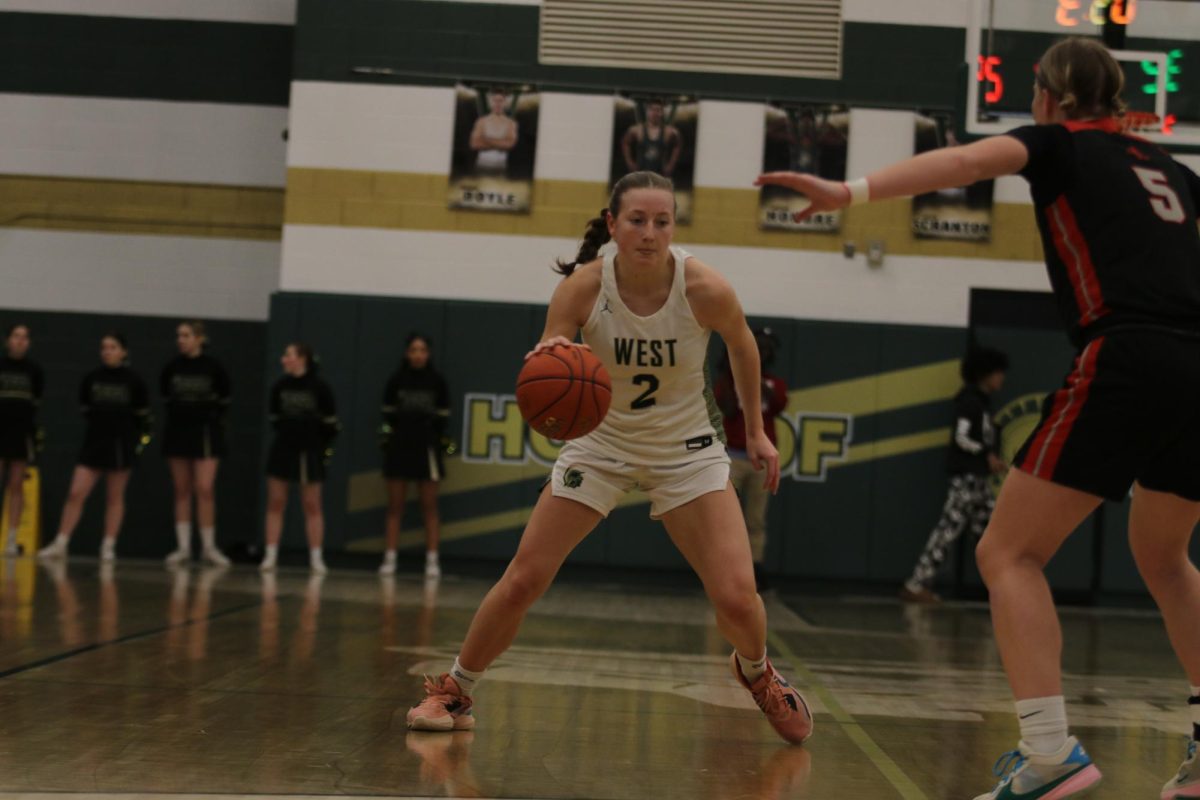 Lucy Wolf '24 dribbles the ball up the court.