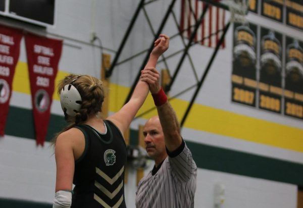 Harper Chase 25 gets her hand raised after pinning her opponent.