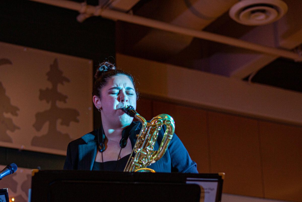 Genna Ray 25 rips up the baritone saxophone for her second solo of the night. 