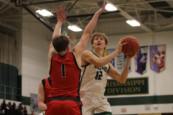 Jacob Koch 24 moves past defenders and goes in for a shot Jan. 19 against Linn-Mar. 