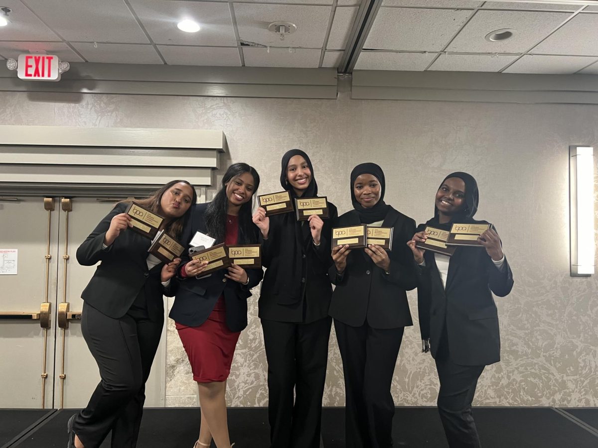 Ciram Shargawi 25, Layan Ahmed 25, Haya Saeed 24, Wesal Haroun 24 and Omnia Ahmed 26 pose with their plaques on stage after the awards ceremony. 