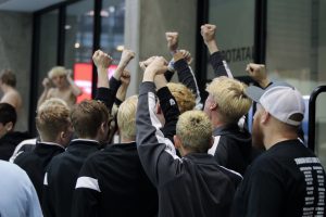 Boys swimming celebrate after setting a new record at the state meet Feb. 11.