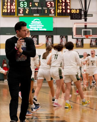 Head Coach; Nate Frese glances at the home crowd as the girls basketball team wins their game. 