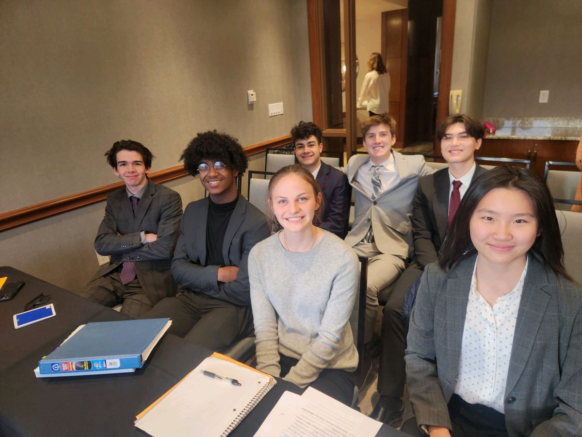 Gold Prosecution poses for a picture before competing against another Mock Trial team during regionals. 