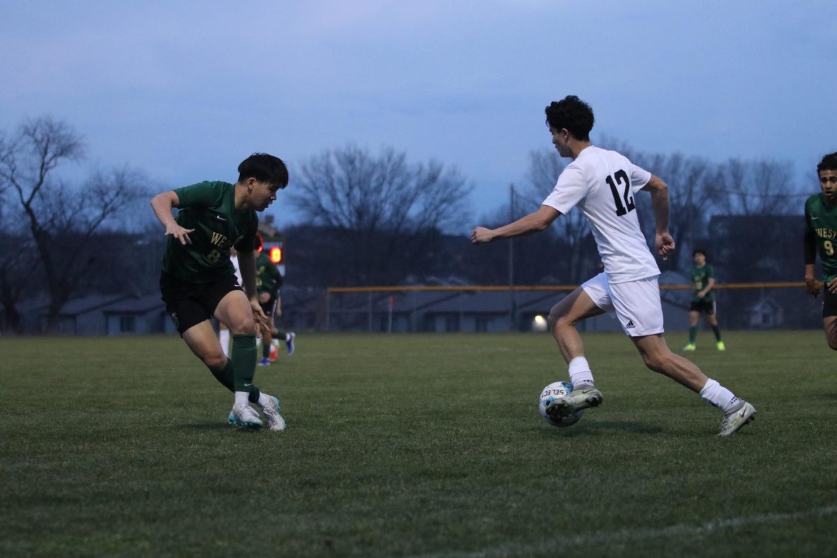 Christian Kim 25 defends the ball from WDM Valley attacker Ademir Zalihic 24 during the game on March 29.