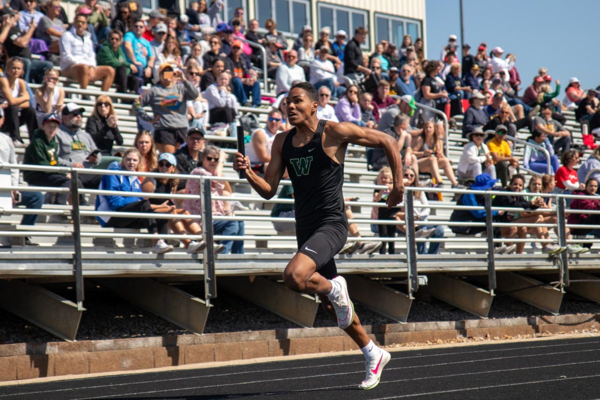 Izaiah Loveless sprints his portion of the sprint medley relay on April 13. 