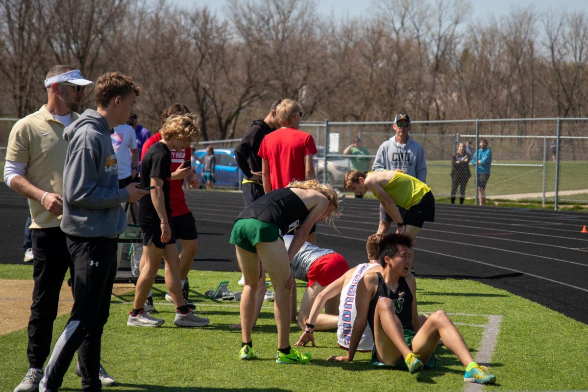 Seniors Michael Lee and Cade Benson catch their breath after they finish their race on April 13. 