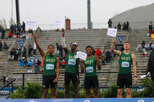 The distance medley relay team celebrates on stage after their historic win at the Drake Relays on April 26.