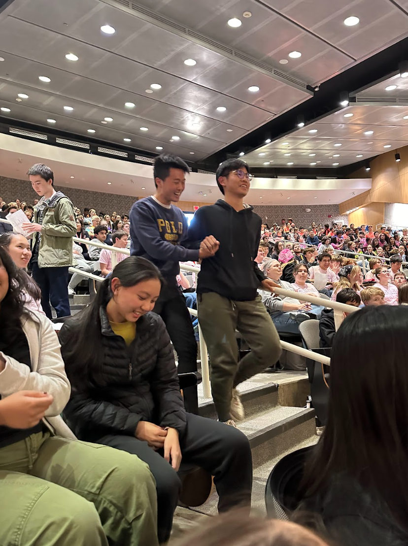 Michael Lee '24 and Derek Hua '25 stride to the front of the auditorium after placing in Anatomy and Physiology.