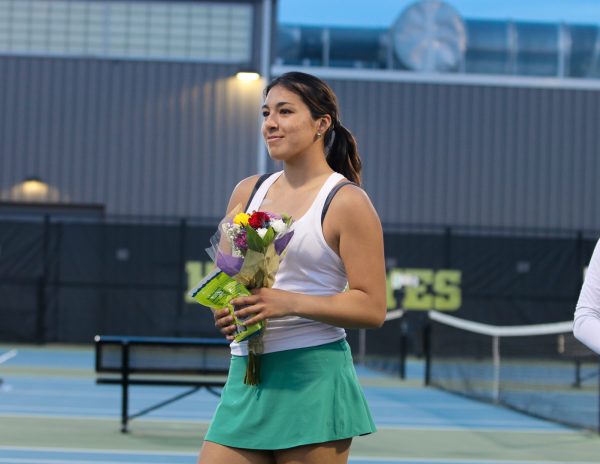 Delmira Jara 24 smiles as she recieves her senior recognition gift and flowers May 1.
