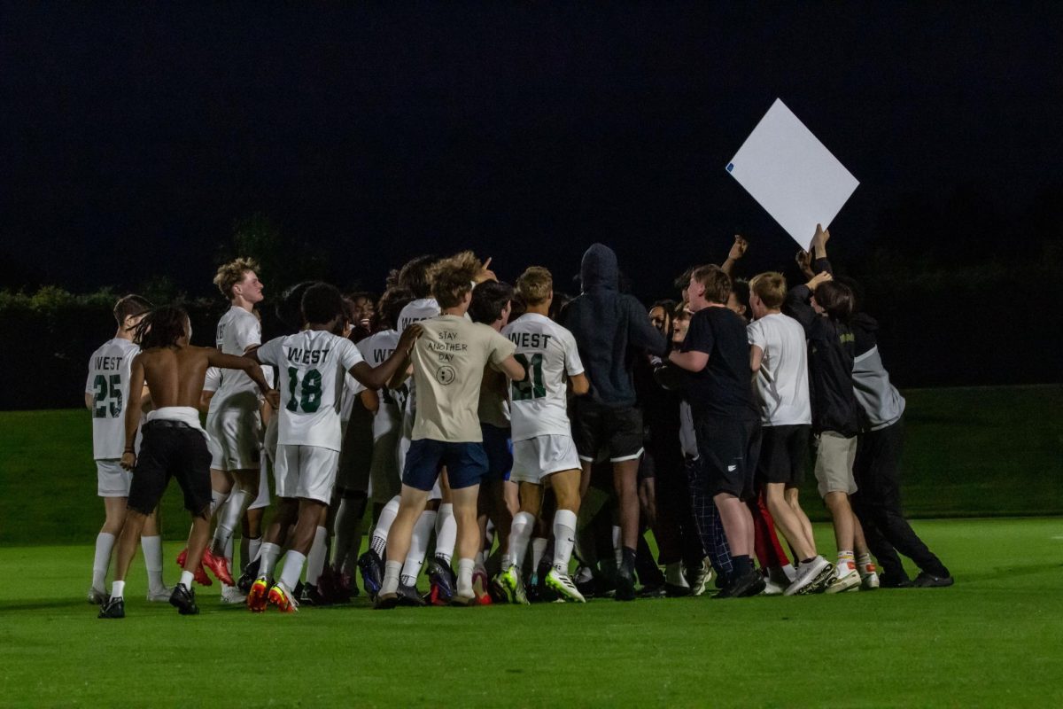 The students and boys soccer team celebrate after the win against City High May 15. 