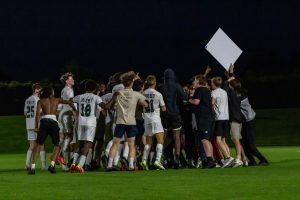The students and boys soccer team celebrate after the win against City High May 15. 