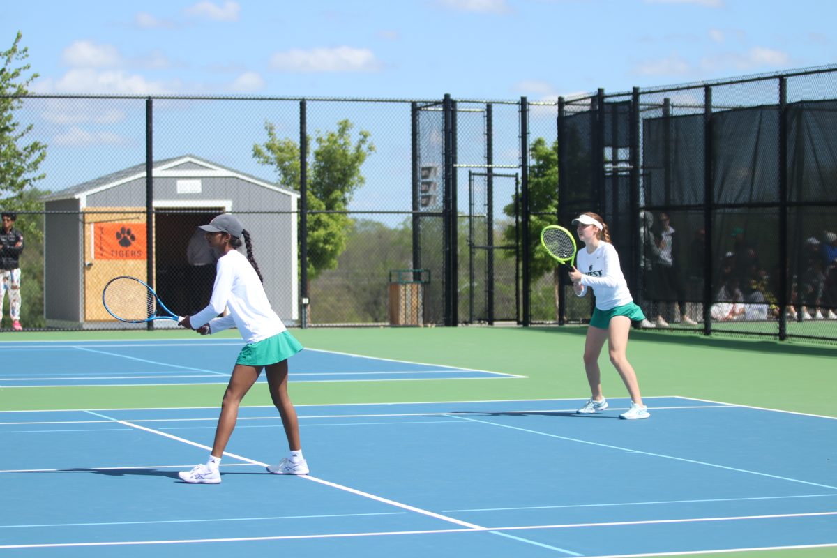 Vismitha Vuppala 24 and Audrey Crawford 26 prepare to return a serve during a point in their second doubles match April 29.  