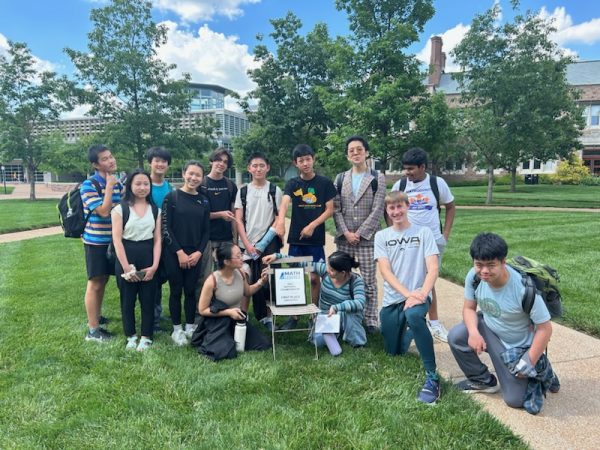 The West High Math Club poses with their plaques and trophies post-competition. From left to right, Aiden Zhang 27, Helena Yang 28,  Kyros Wu 28, Erin Chen 27, Waylon Houchins-Witt 25, Shannon Chen 27, Ethan Ding 28, Conan Chen 27, Catherine Xu 26, Edward Li 26, Kai Merrill 27, Prabhas Gupta 28, Andrew Chen 25.  
