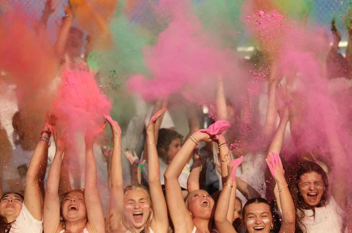 The West student section celebrates a touchdown by throwing up chalk.