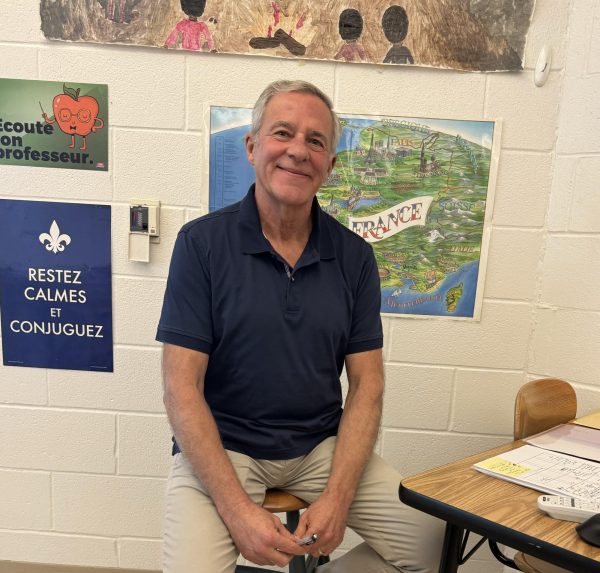 Guy Bouchet sitting at his desk 