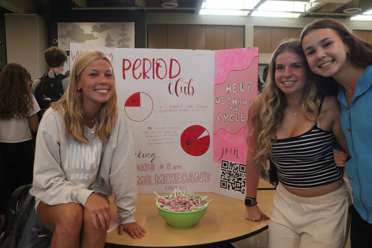 Seniors Ava Bruxvoort, Sidney Tranel and Sasha Postnikov endorse Period Club. On Sept. 11, the group incentivized sign ups by giving out candy.