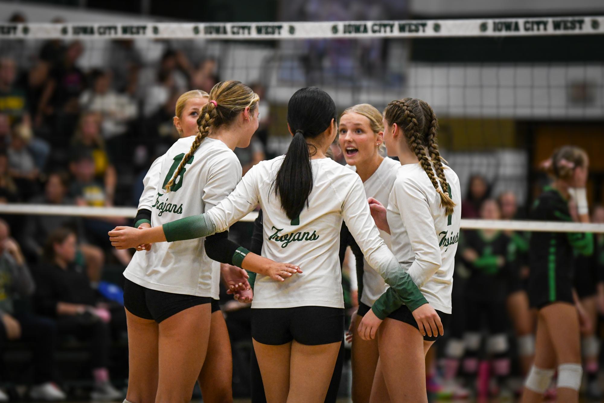 Sophia Bodin '25 leads a team huddle between plays against Cedar Rapids Kennedy.