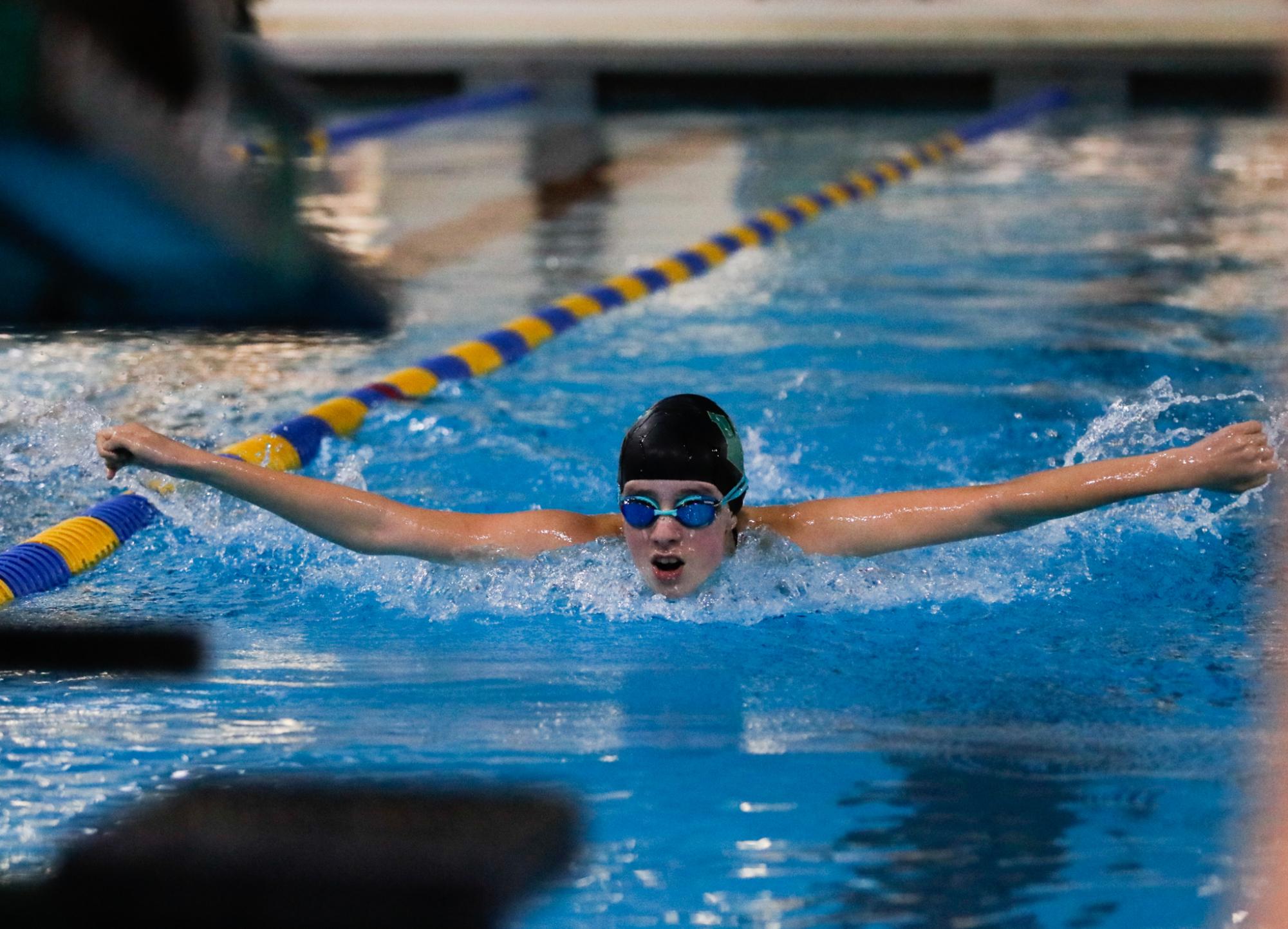 Emma O'Neill '28 swims the 100Y Butterfly at the last home meet of the season Oct. 1. 