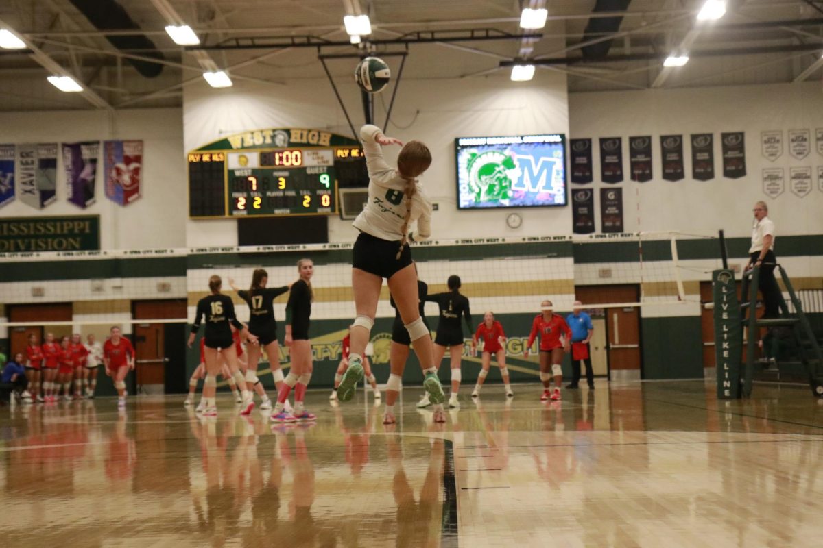 Number eight Emma Fish ’25 takes the first serve of the match to kick off the semifinal match between West High and Marshalltown.