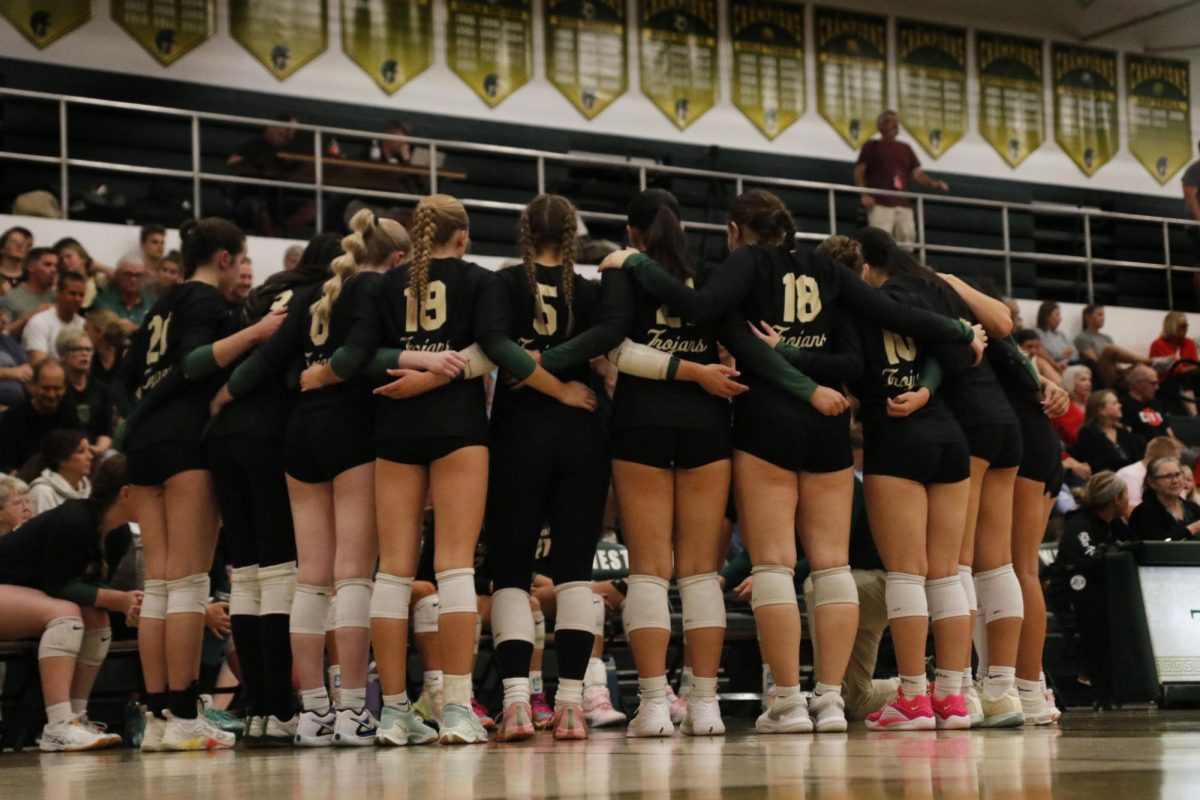 The girls volleyball team huddles together to discuss tactics for their final set against City High on Oct. 3.